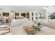 Open-concept living space with contemporary sofas, kitchen views, and modern décor at 7613 Wandering Way, Orlando, FL 32836