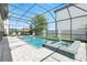 A screened-in pool and hot tub sit with a patio and lounge chairs for relaxation and recreation at 7613 Wandering Way, Orlando, FL 32836
