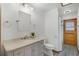 Bright bathroom featuring a marble vanity, framed mirror, and a tiled walk-in shower at 8665 Vista Point Cv, Orlando, FL 32836