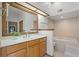 The primary bathroom features a bathtub and an oversized mirror above the sink at 8665 Vista Point Cv, Orlando, FL 32836