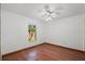 This empty bedroom features hardwood flooring and a window for natural light at 8665 Vista Point Cv, Orlando, FL 32836