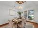 Well-lit dining room featuring a modern chandelier, wood floors, and seating for six at 8665 Vista Point Cv, Orlando, FL 32836