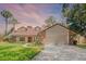 Charming single-Gathering home featuring a two-car garage, dormer windows, and a well-manicured lawn at 8665 Vista Point Cv, Orlando, FL 32836