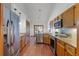 Well-equipped kitchen featuring stainless steel appliances and granite countertops with wooden cabinets at 8665 Vista Point Cv, Orlando, FL 32836