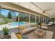 Relaxing screened lanai with comfortable seating overlooking a beautiful swimming pool and private backyard at 8665 Vista Point Cv, Orlando, FL 32836