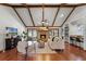 Cozy living room features vaulted ceilings, hardwood floors, a brick fireplace, and access to backyard at 8665 Vista Point Cv, Orlando, FL 32836