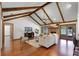 Spacious living room with vaulted ceilings, wood beams, fireplace, and access to the outdoor pool area at 8665 Vista Point Cv, Orlando, FL 32836