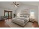 This primary bedroom offers a ceiling fan, french doors, and an ensuite bathroom at 8665 Vista Point Cv, Orlando, FL 32836