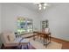 Bright home office with natural light, featuring a wooden desk, a comfortable chair, and a bookshelf at 8665 Vista Point Cv, Orlando, FL 32836