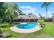 Backyard view featuring a sparkling in-ground pool and a covered patio, perfect for outdoor entertaining at 8665 Vista Point Cv, Orlando, FL 32836