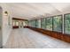 Enclosed sunroom with white tile flooring, wood trim, and bright windows at 917 Great Bend Rd, Altamonte Springs, FL 32714