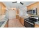 Functional kitchen featuring updated stainless steel appliances, wood cabinets, granite countertops and tile floors at 917 Great Bend Rd, Altamonte Springs, FL 32714