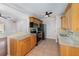 Well-lit kitchen with stainless steel appliances, granite countertops, updated cabinetry and tile flooring at 917 Great Bend Rd, Altamonte Springs, FL 32714
