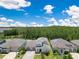 Beautiful aerial view of a home featuring a well manicured lawn, brick driveway, and a three car garage at 9426 Launch Point Rd, Orlando, FL 32832