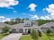 Aerial view of a lovely home with a three-car garage and paved driveway at 9426 Launch Point Rd, Orlando, FL 32832