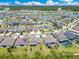 This aerial view highlights community homes, a lake, and attractive manicured lawns at 9426 Launch Point Rd, Orlando, FL 32832