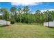 Beautiful backyard with a large grassy area and privacy fence, perfect for outdoor activities at 9426 Launch Point Rd, Orlando, FL 32832