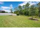 Large backyard with a lush lawn, trees and fenced perimeter at 9426 Launch Point Rd, Orlando, FL 32832
