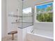 Bright bathroom with a luxurious bathtub, shower, and large window at 9426 Launch Point Rd, Orlando, FL 32832