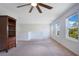 Spacious bonus room featuring a ceiling fan, bright windows, carpeted flooring, and neutral paint at 9426 Launch Point Rd, Orlando, FL 32832