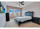 A bedroom featuring three bright windows, a ceiling fan, and black bedroom set at 9426 Launch Point Rd, Orlando, FL 32832