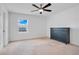 Bright bedroom features a ceiling fan, neutral carpet, and a large window at 9426 Launch Point Rd, Orlando, FL 32832