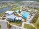 An aerial view of the community pool, buildings and the recreation area surrounded by palm trees at 9426 Launch Point Rd, Orlando, FL 32832