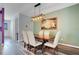 The dining area has an elegant chandelier and a large painting on the wall at 9426 Launch Point Rd, Orlando, FL 32832