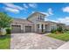 Charming two-story home with a three-car garage and well-manicured landscaping at 9426 Launch Point Rd, Orlando, FL 32832