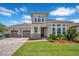 Beautiful two-story home with a well-manicured lawn and a three-car garage at 9426 Launch Point Rd, Orlando, FL 32832