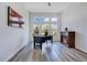 Bright home office with a fireplace, large windows, and a modern desk setup at 9426 Launch Point Rd, Orlando, FL 32832