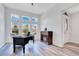 Comfortable home office with a fireplace, modern desk setup, large windows, and ample lighting at 9426 Launch Point Rd, Orlando, FL 32832