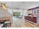 Open-concept kitchen and dining area with modern lighting and view to the living room at 9426 Launch Point Rd, Orlando, FL 32832