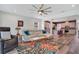 Relaxing living room open to kitchen, with modern ceiling fan and ample natural light at 9426 Launch Point Rd, Orlando, FL 32832