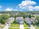 Aerial view of the two-story home with a well-maintained lawn in a neighborhood with mature trees on a sunny day at 9846 Palmetto Dunes Ct, Orlando, FL 32832