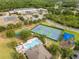 Aerial view showcasing community amenities: tennis courts, basketball court, pool, and playground, ideal for recreation at 9846 Palmetto Dunes Ct, Orlando, FL 32832