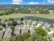 Aerial view of homes near a pond and golf course showcasing a scenic community and neighborhood amenities at 9846 Palmetto Dunes Ct, Orlando, FL 32832