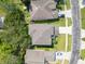 Aerial view of the home's roof, driveway, and surrounding neighborhood with well-manicured lawns and mature trees at 9846 Palmetto Dunes Ct, Orlando, FL 32832