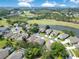 An aerial image shows a neighborhood with a lake, golf course, and lush greenery at 9846 Palmetto Dunes Ct, Orlando, FL 32832