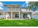 Backyard view showcasing a covered patio, second story balcony, and outdoor seating area perfect for entertaining at 9846 Palmetto Dunes Ct, Orlando, FL 32832