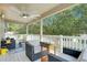 Covered balcony with wicker furniture, a ceiling fan, and green tree views at 9846 Palmetto Dunes Ct, Orlando, FL 32832