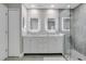 Bathroom with a double vanity, walk-in shower and modern backlit mirrors at 9846 Palmetto Dunes Ct, Orlando, FL 32832