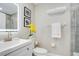 Modern bathroom with a sleek vanity, illuminated mirror, and contemporary fixtures at 9846 Palmetto Dunes Ct, Orlando, FL 32832