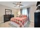 Comfortable bedroom with a plaid comforter, a large mirror, and stylish furnishings at 9846 Palmetto Dunes Ct, Orlando, FL 32832