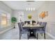 Elegant dining room with modern light fixture and seating for six at 9846 Palmetto Dunes Ct, Orlando, FL 32832