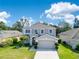 Well-maintained two-story home with a two-car garage, manicured lawn, and inviting curb appeal on a sunny day at 9846 Palmetto Dunes Ct, Orlando, FL 32832