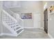 Bright foyer with a staircase, tile floors, and contemporary artwork at 9846 Palmetto Dunes Ct, Orlando, FL 32832
