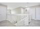 Spacious upper hallway featuring a white wood railing, neutral paint, and wood-look floors at 9846 Palmetto Dunes Ct, Orlando, FL 32832
