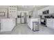 Bright kitchen features stainless steel appliances, white cabinetry, quartz countertops, and a kitchen island at 9846 Palmetto Dunes Ct, Orlando, FL 32832