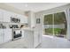 Bright kitchen with stainless appliances features a kitchen island and access to the outdoor patio at 9846 Palmetto Dunes Ct, Orlando, FL 32832